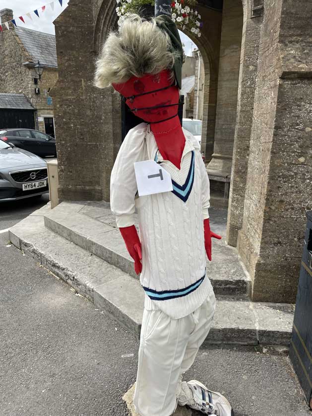 A cricketer outside the Market Cross.