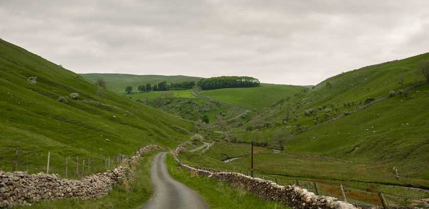 The North York Moors with rolling hills, drystone walls, and sheep grazing © Kath Aggiss.