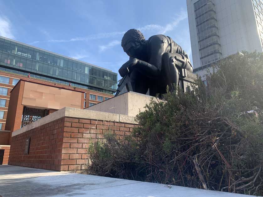 <figcaption>6-tonne, 12-foot bronze statue by sculptor Eduardo Paolozzi in the Piazza.