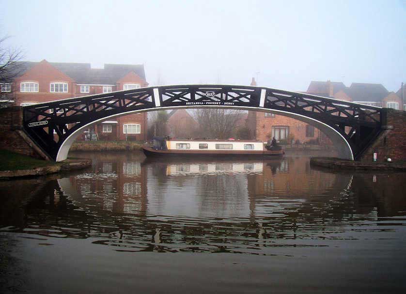 An elegant cast-iron bridge crosses the Oxford Canal where it meets the Coventry Canal.