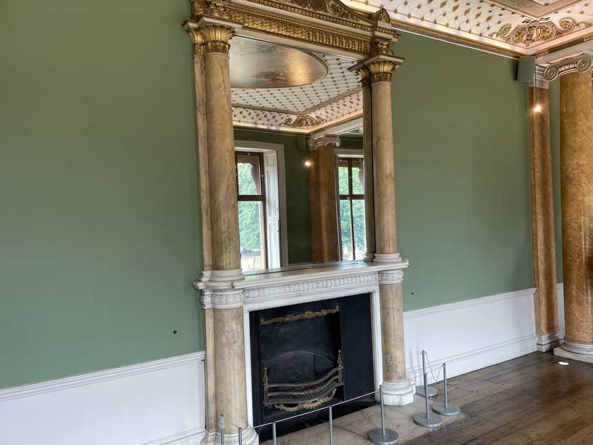 A fireplace and mirror in the museum.
