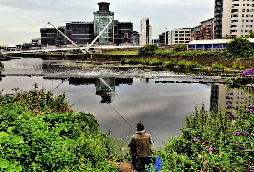 The River Aire in Leeds with the redeveloped Leeds Dock in the background.