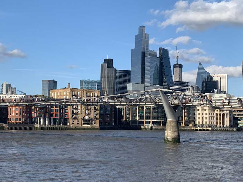 High rise London in 2023 seen from south of the river with Millennium Bridge in the foreground.