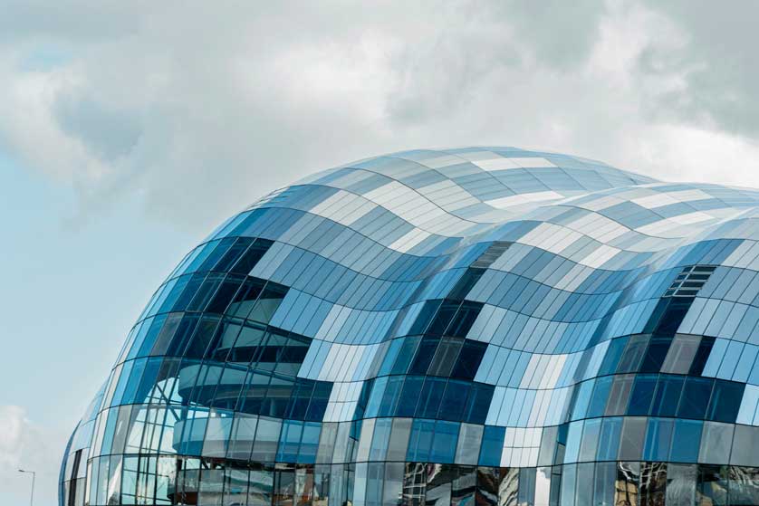 The sweeping curves and glass fa&ccedil;ade of The Glasshouse International Centre for Music.