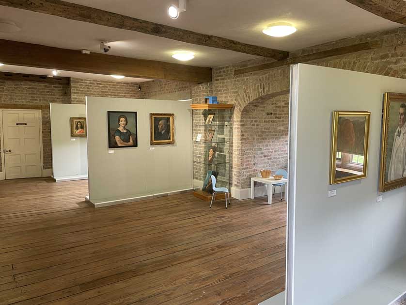 Portraits on display of some of the people associated with Ordsall Hall.