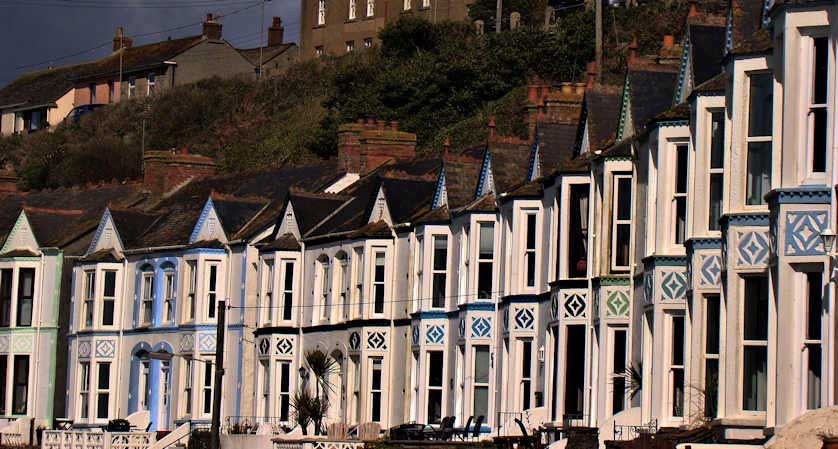 Harbour Road in Porthleven with a terrace of houses overlooking the harbour.