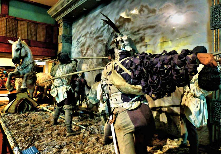 Various tableau depict scenes form warfare.